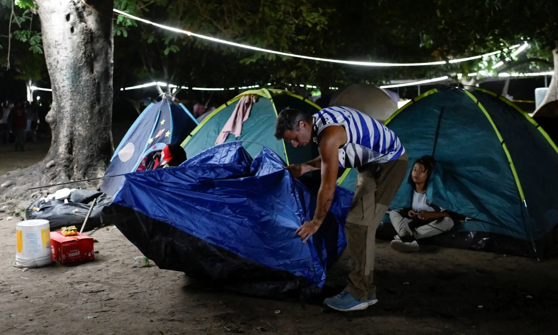 A man displaced by the earthquakes that struck the country on June 24, sets up a tent in a park, in Caracas, Venezuela, July 1, 2026. - Reuters
