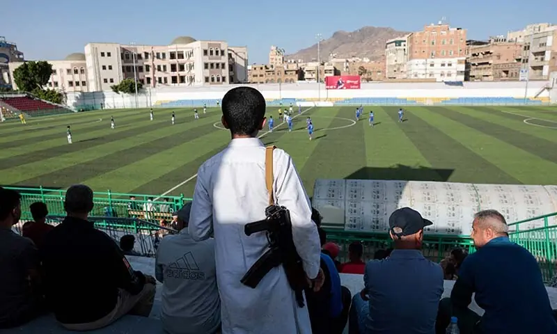 A boy carries a rifle as he watches a football match in Sanaa, Yemen on June 20, 2026. &mdash; Reuters/File