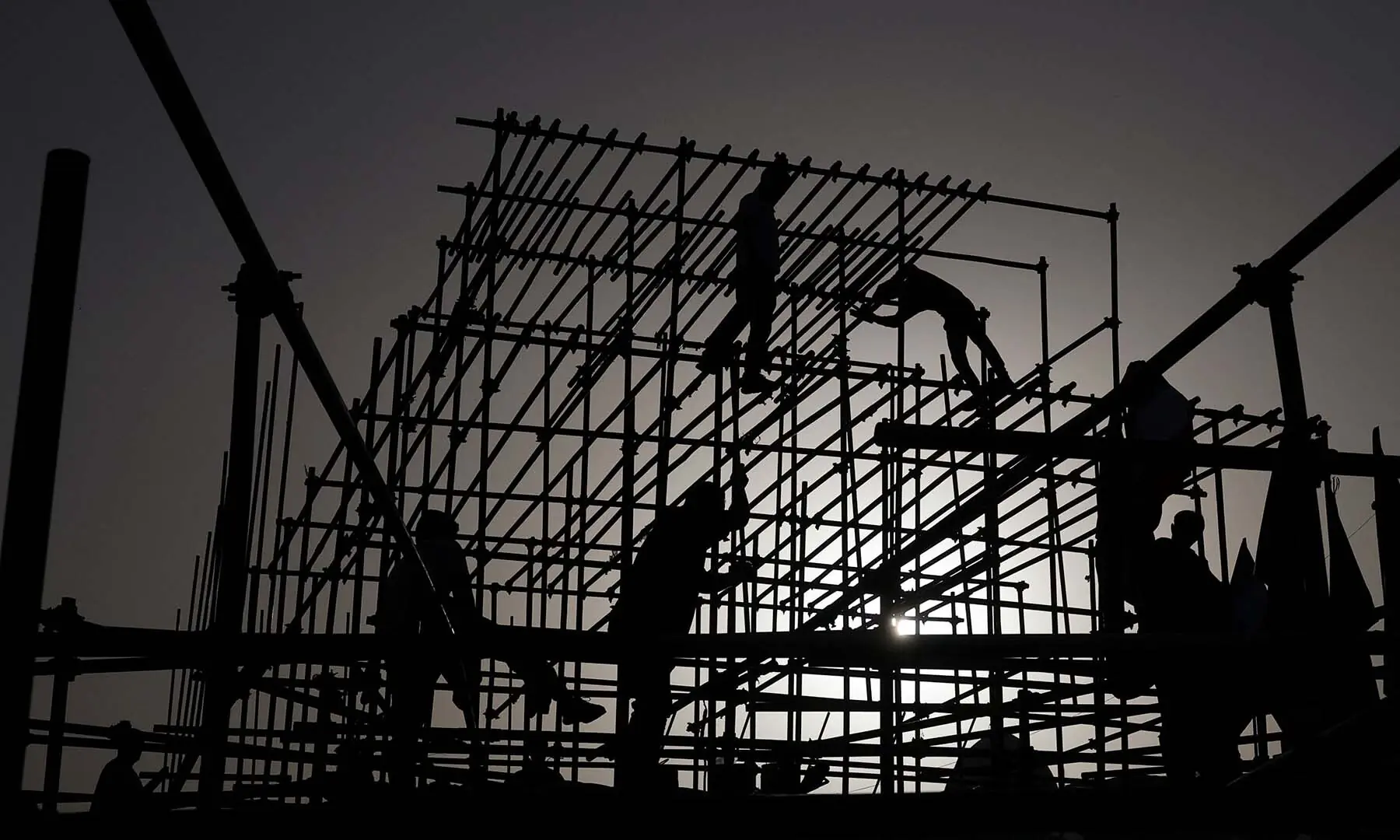 Workers on scaffolding during preparations for a farewell ceremony for Iran’s late Supreme Leader Ayatollah Ali Khamenei at Enghelab Square in Tehran, Iran on July 2, 2026. — Reuters