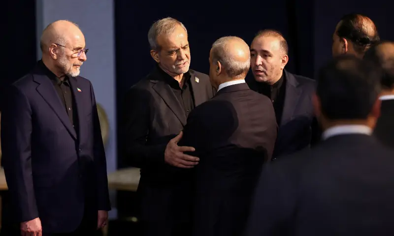 Iranian President Masoud Pezeshkian embraces Prime Minister Shehbaz Sharif as they attend a farewell ceremony for Iran's late Supreme Leader Ayatollah Ali Khamenei, for international delegates at the Imam Khomeini Grand Mosalla in Tehran, Iran on July 3, 2026. &mdash; Reuters