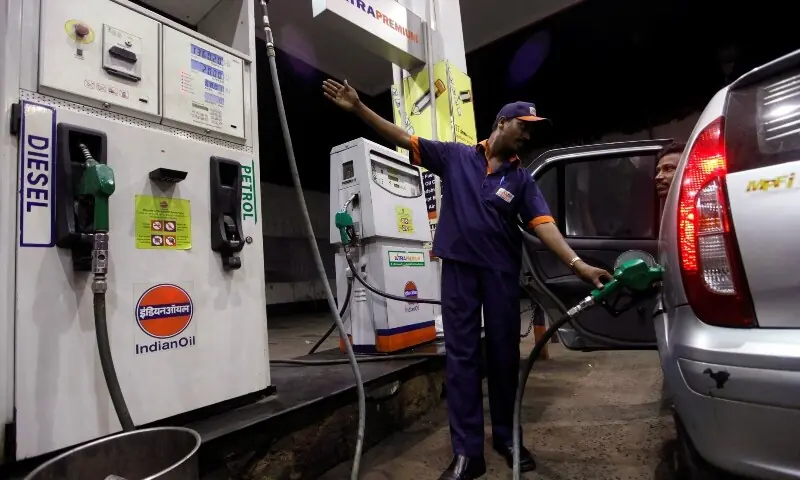 A worker fills a car with petrol as he gestures towards the fuel barometer for the passenger to check, at a fuel station in Kolkata September 15, 2011. — Reuters/File A worker fills a car with petrol as he gestures towards the fuel barometer for the passenger to check, at a fuel station in Kolkata September 15, 2011. — Reuters/File