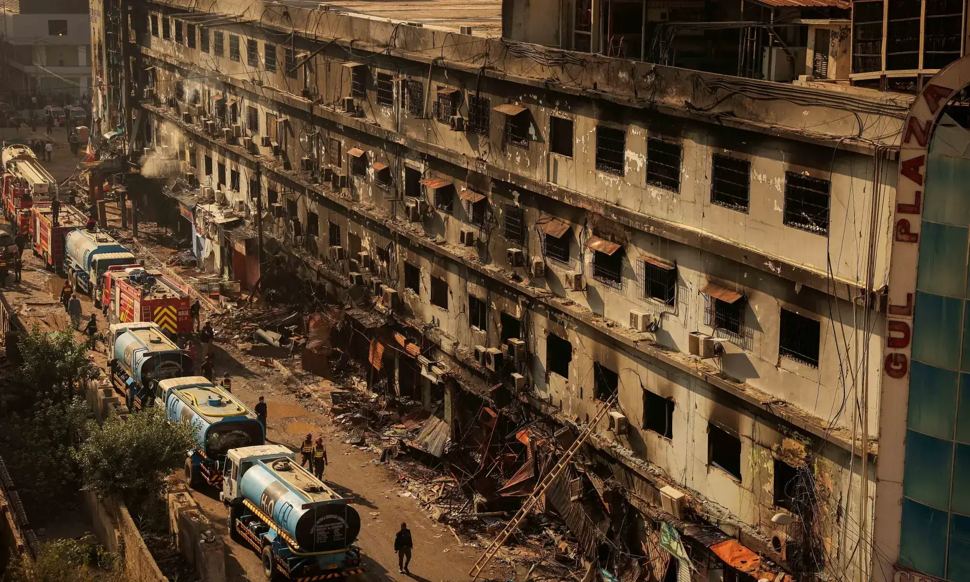 Fire department workers walk past the site, following a massive fire that broke out in the Gul Plaza Shopping Mall in Karachi on January 20, 2025. — Reuters/File Fire department workers walk past the site, following a massive fire that broke out in the Gul Plaza Shopping Mall in Karachi on January 20, 2025. — Reuters/File