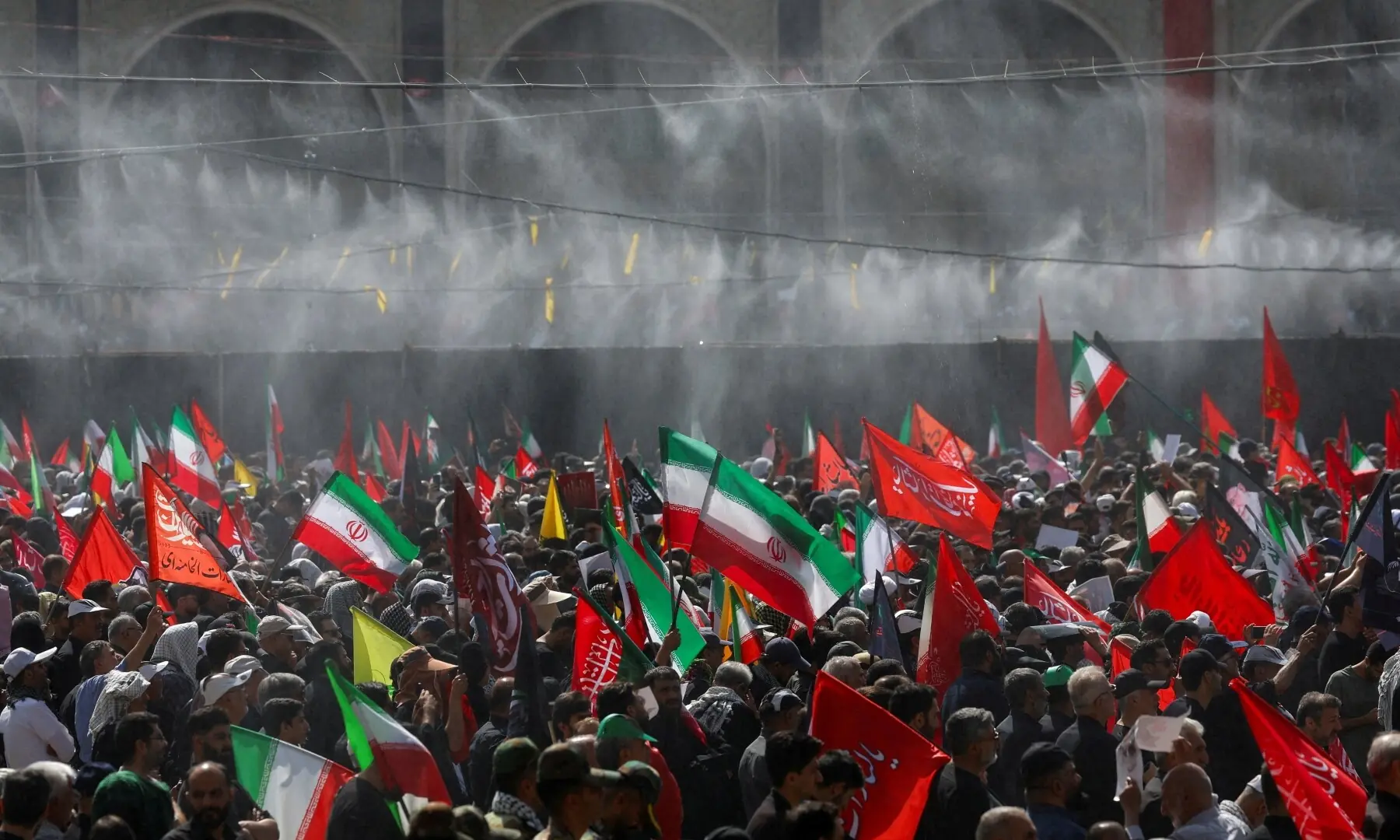 Water is sprayed on people attending a public farewell ceremony to pay their respects to late Supreme Leader Ayatollah Ali Khamenei, who was killed on February 28 in Israeli and US airstrikes, at the Imam Khomeini Grand Mosalla, in Tehran, Iran on July 4, 2026. - Reuters