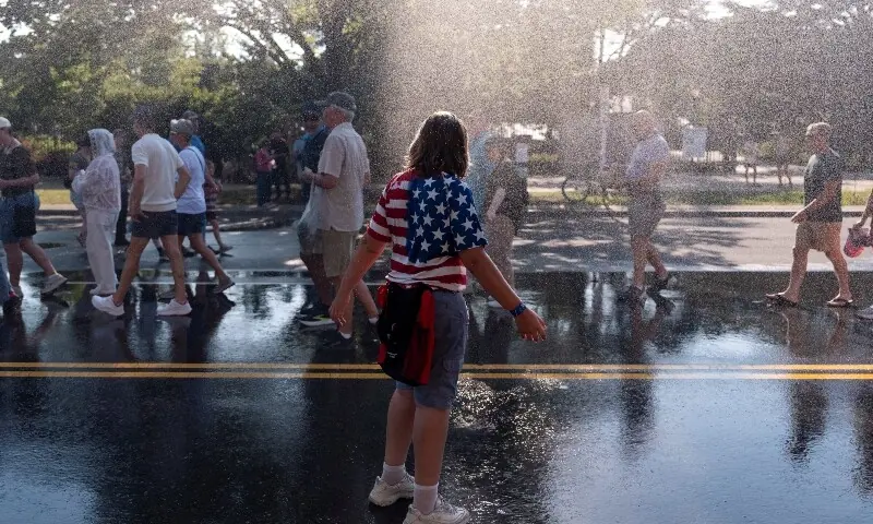 A person cools off in the spray of water after a temporary closure of The Great American State Fair due to heat on the National Mall in Washington, DC, US, July 3, 2026. —AFP