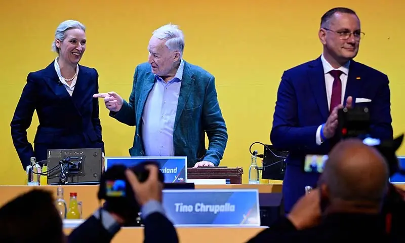 AfD co-leaders Tino Chrupalla (R) and Alice Weidel (L) and honorary chairman Alexander Gauland greet delegates at the party congress of the far-right Alternative for Germany (AfD) at the Messe Erfurt fairground in Erfurt, eastern Germany on July 4, 2026. — AFP