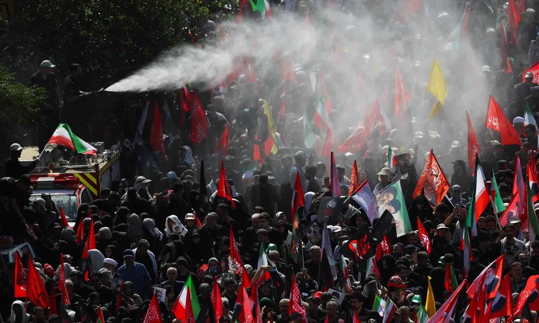 Water is sprayed as mourners gather on the day of a funeral procession for Iran&rsquo;s assassinated Supreme Leader Ayatollah Ali Khamenei in Tehran, Iran, July 6, 2026. &mdash; Reuters