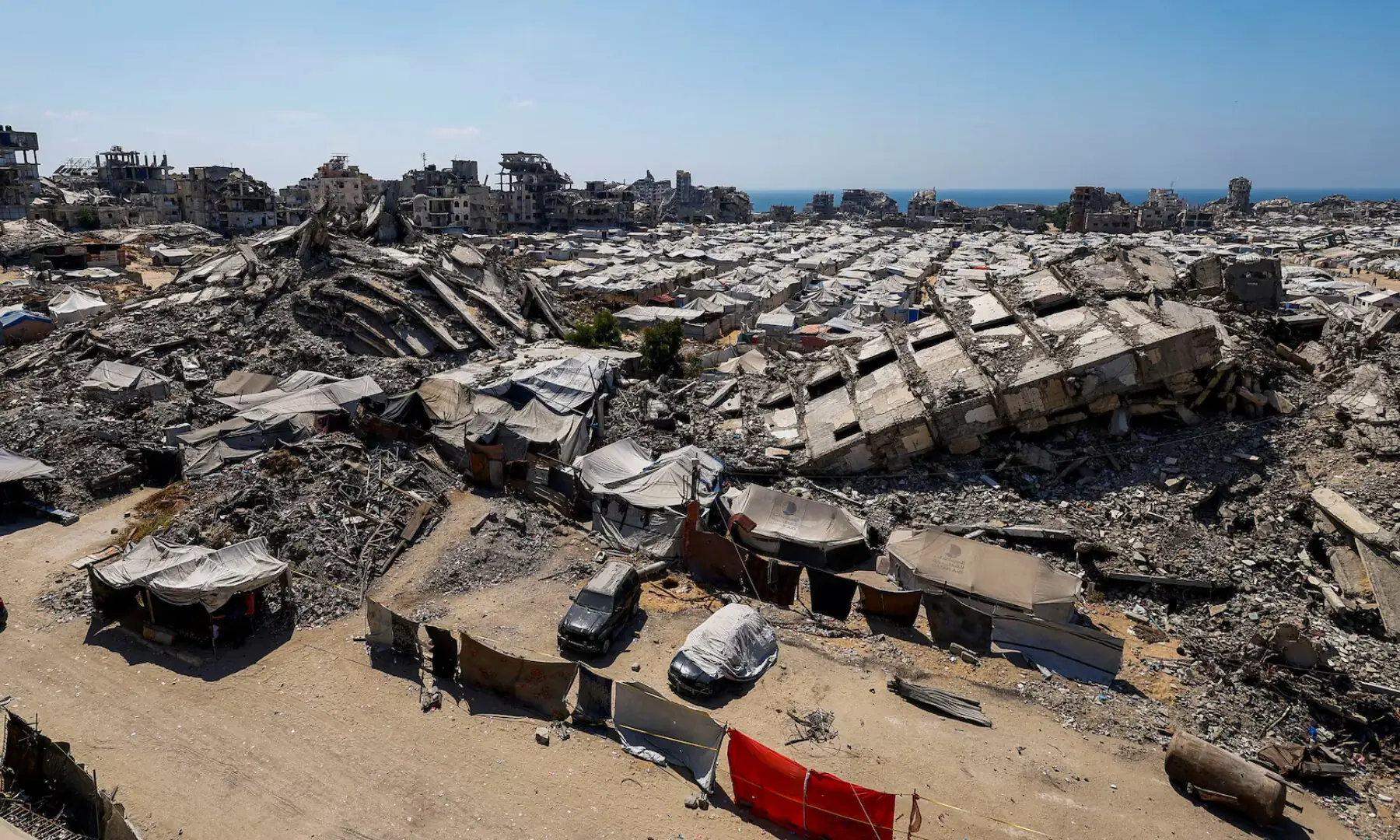 A general view of the rubble of residential buildings destroyed during the Israeli offensive and tents sheltering displaced Palestinians in Gaza City, on July 4, 2026. &mdash; Reuters
