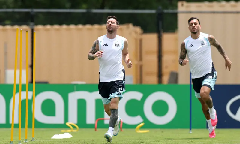 KENNESAW (Georgia): Argentina players Lionel Messi (L) and Leandro Paredes warm up during a training session at the Kennesaw State University on Monday.—Reuters KENNESAW (Georgia): Argentina players Lionel Messi (L) and Leandro Paredes warm up during a training session at the Kennesaw State University on Monday.—Reuters