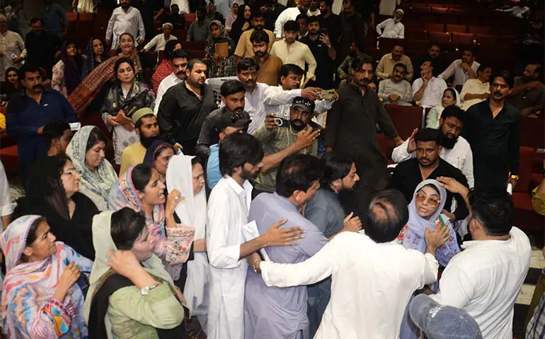 A PTI woman councillor being forced to leave over her ‘offending’ remarks against the mayor during the HMC budget session.—Dawn A PTI woman councillor being forced to leave over her ‘offending’ remarks against the mayor during the HMC budget session.—Dawn