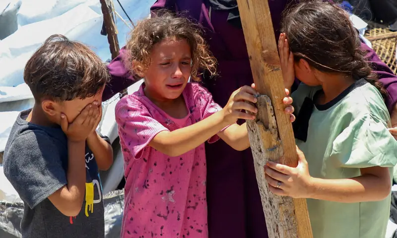 CHILDREN react as their family inspect the site of an Israeli strike on a camp sheltering displaced Palestinians in Gaza City.—Reuters CHILDREN react as their family inspect the site of an Israeli strike on a camp sheltering displaced Palestinians in Gaza City.—Reuters