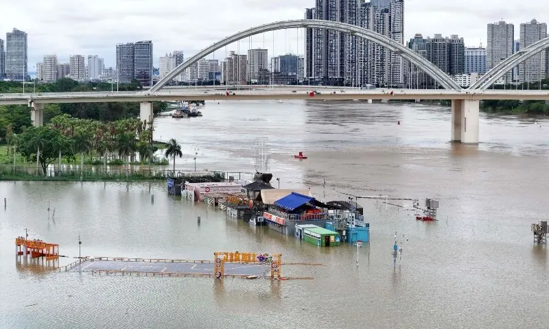 Flooded shops along a submerged riverside walk are seen by the overflowing Yongjiang river in Nanning, in China’s southern Guangxi region on July 7, 2026. —AFP Flooded shops along a submerged riverside walk are seen by the overflowing Yongjiang river in Nanning, in China’s southern Guangxi region on July 7, 2026. —AFP