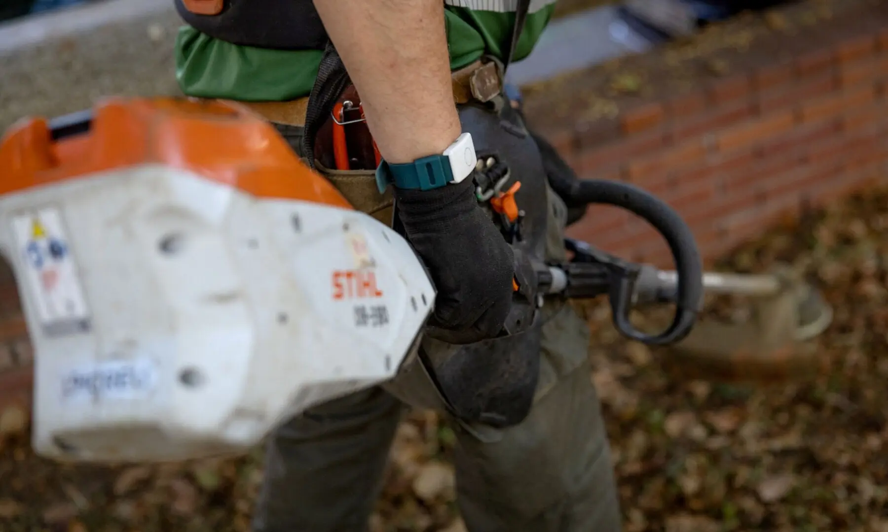 A gardener works with a wristband containing a sensor that detects body temperature in Barcelona on July 6, 2026. — AFP