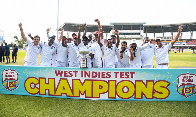 WEST INDIES players celebrate winning with the Sobers and Tissera trophy at the end of the second Test against Sri Lanka at the Vivian Richards Cricket Stadium.—AFP WEST INDIES players celebrate winning with the Sobers and Tissera trophy at the end of the second Test against Sri Lanka at the Vivian Richards Cricket Stadium.—AFP