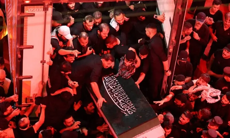 People unload the coffin of Iran&rsquo;s late Supreme Leader Ayatollah Ali Khamenei, who was killed on February 28 in Israeli and US airstrikes, from a refrigeration vehicle, during his funeral procession, in Karbala, Iraq, July 9, 2026. &mdash;AFP