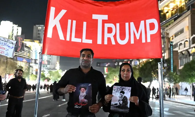 Mourners display an anti-US banner as they arrive near Imam Reza&rsquo;s shrine for the funeral of slain Iranian leader Ali Khamenei and members of his family in Mashhad early on July 9, 2026.  &mdash; AFP