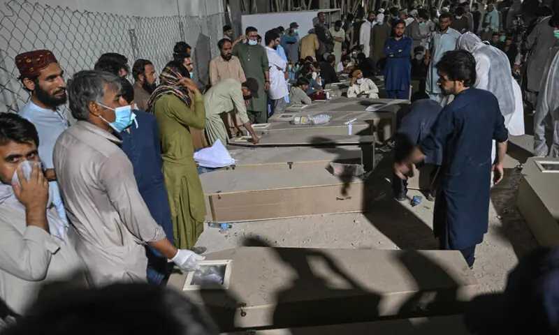 QUETTA: Mourners are seen beside the coffins of police personnel martyred in the Ziarat terrorist attack.—AFP QUETTA: Mourners are seen beside the coffins of police personnel martyred in the Ziarat terrorist attack.—AFP