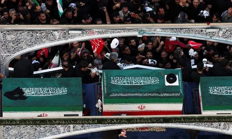 Mourners accompany a vehicle transporting the coffin of Iran's assassinated Supreme Leader Ayatollah Ali Khamenei and coffins of his family members, on the day of his burial, in a culmination of a mass funeral, in Mashhad, Iran, July 9, 2026. &mdash; Reuters
