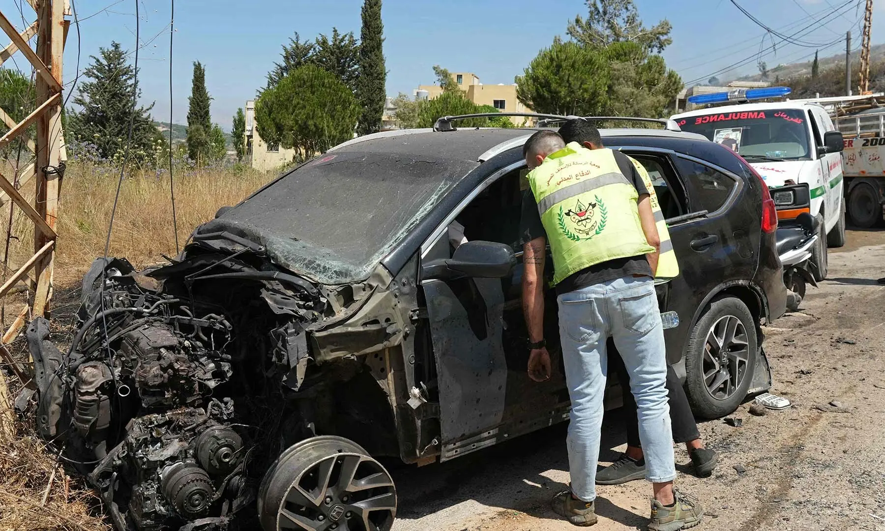 First responders inspect a vehicle that was reportedly damaged by an Israeli strike in the southern Lebanese village of Kfar Roummane on July 10, 2026. &mdash; AFP