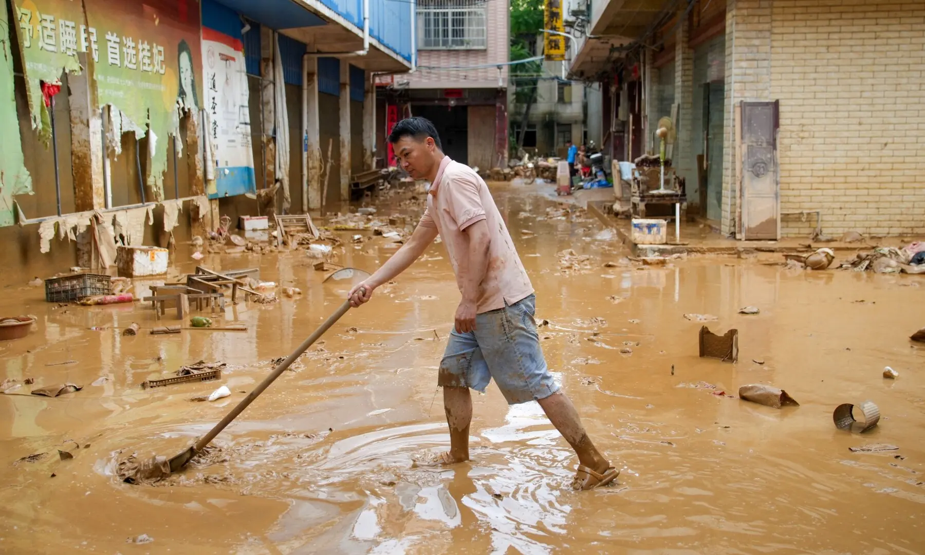 A man clears mud after heavy rainfall brought by typhoon Maysak in flooded Sanli town in Guigang, Guangxi Zhuang Autonomous Region, China July 9, 2026. —Reuters