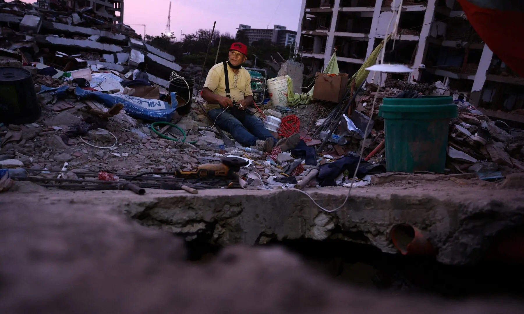Julio Dimas, 60, sits on debris as he searches for his daughter, Annett Andrade, and his son-in-law following the June 24 earthquakes, in La Guaira, Venezuela, July 10, 2026. — Reuters