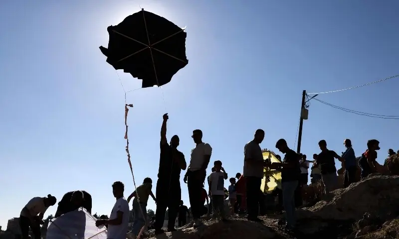 Palestinians and solidartiy activists fly kites towards the Israeli settelment of Har Bracha from the village of Burin, south of Nablus in the occupied West Bank on July 10, 2026. —AFP