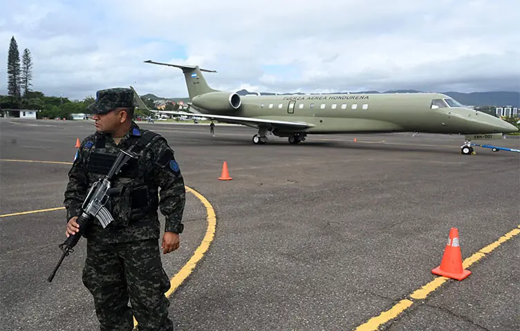 A soldier stands guard by the Honduran presidential aeroplane, which will be auctioned off as part of austerity measures, as it remains parked at the Hernan Acosta Mejia Air Base in Tegucigalpa. The Embraer Legacy 600 jet, whose purchase and maintenance have been marred by allegations of corruption, was acquired by Honduran President Juan Orlando Hernández (2014–2022).—AFP A soldier stands guard by the Honduran presidential aeroplane, which will be auctioned off as part of austerity measures, as it remains parked at the Hernan Acosta Mejia Air Base in Tegucigalpa. The Embraer Legacy 600 jet, whose purchase and maintenance have been marred by allegations of corruption, was acquired by Honduran President Juan Orlando Hernández (2014–2022).—AFP