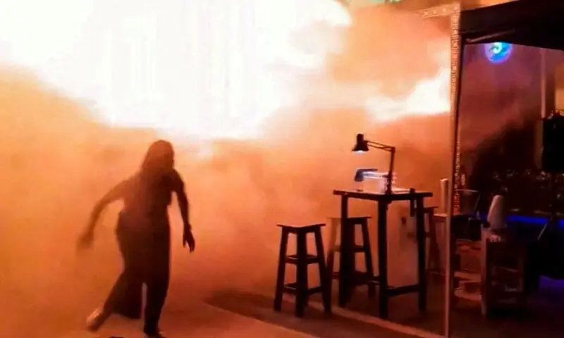 A person runs as flames rise at a pub in Bangkok, Thailand, in this screengrab taken from a social media video released July 13, 2026. — Reuters A person runs as flames rise at a pub in Bangkok, Thailand, in this screengrab taken from a social media video released July 13, 2026. — Reuters