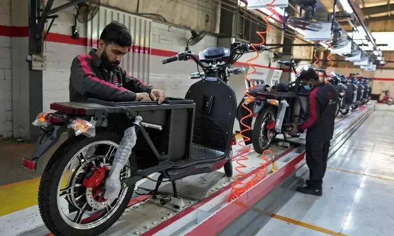 Workers assemble parts of electric motorcycles on the production line at the ZYP Technology's facility in Lahore, Pakistan, March 12, 2025. &mdash;Reuters/File