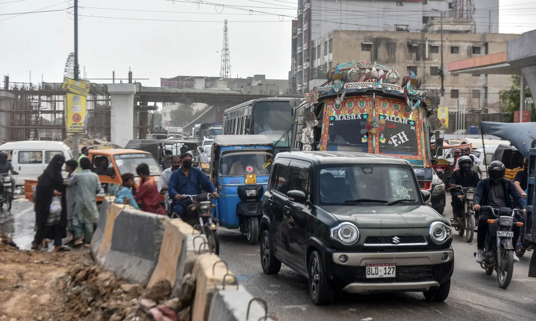 Heavy traffic on a partially dug-up road in Karachi. &mdash; White Star