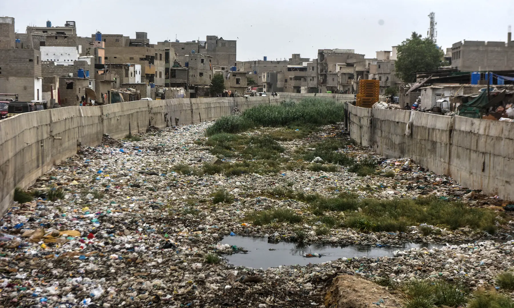 Accumulated trash floats on the surface of a nullah in Karachi. &mdash; White Star