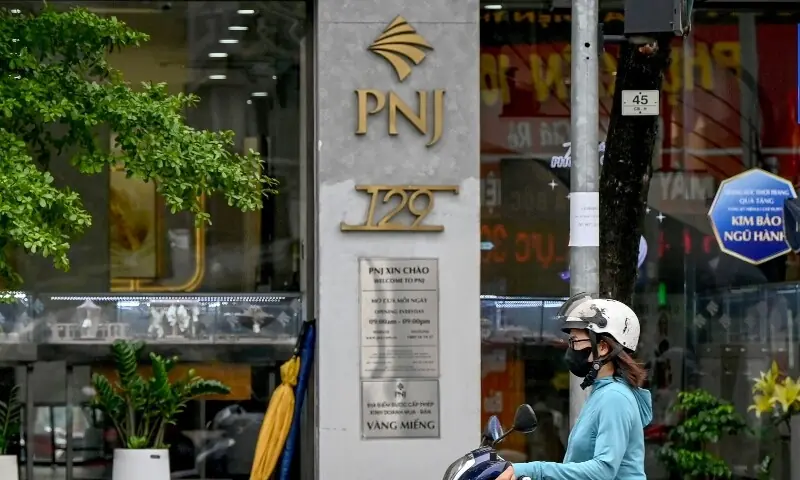 A woman rides a motorbike past a Phu Nhuan Jewelry (PNJ) store in Hanoi on July 15, 2026. —AFP A woman rides a motorbike past a Phu Nhuan Jewelry (PNJ) store in Hanoi on July 15, 2026. —AFP