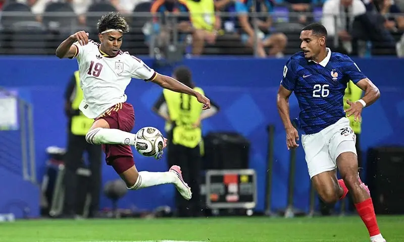 Spain’s Lamine Yamal (L) controls the ball next to France’s Maxence Lacroix (R) during the 2026 FIFA World Cup semi-final match between France and Spain at the Dallas Stadium in Arlington, Texas, the US on July 14, 2026. — AFP