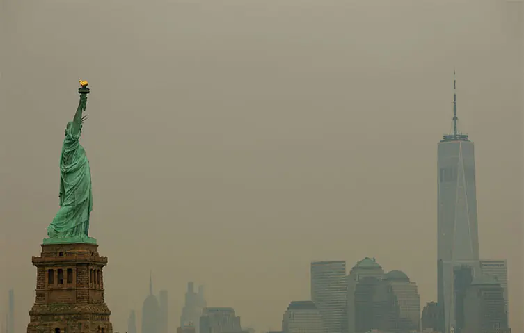 THE Statue of Liberty and the One World Trade Center tower are seen through a cover of wildfire smoke.&mdash;Reuters