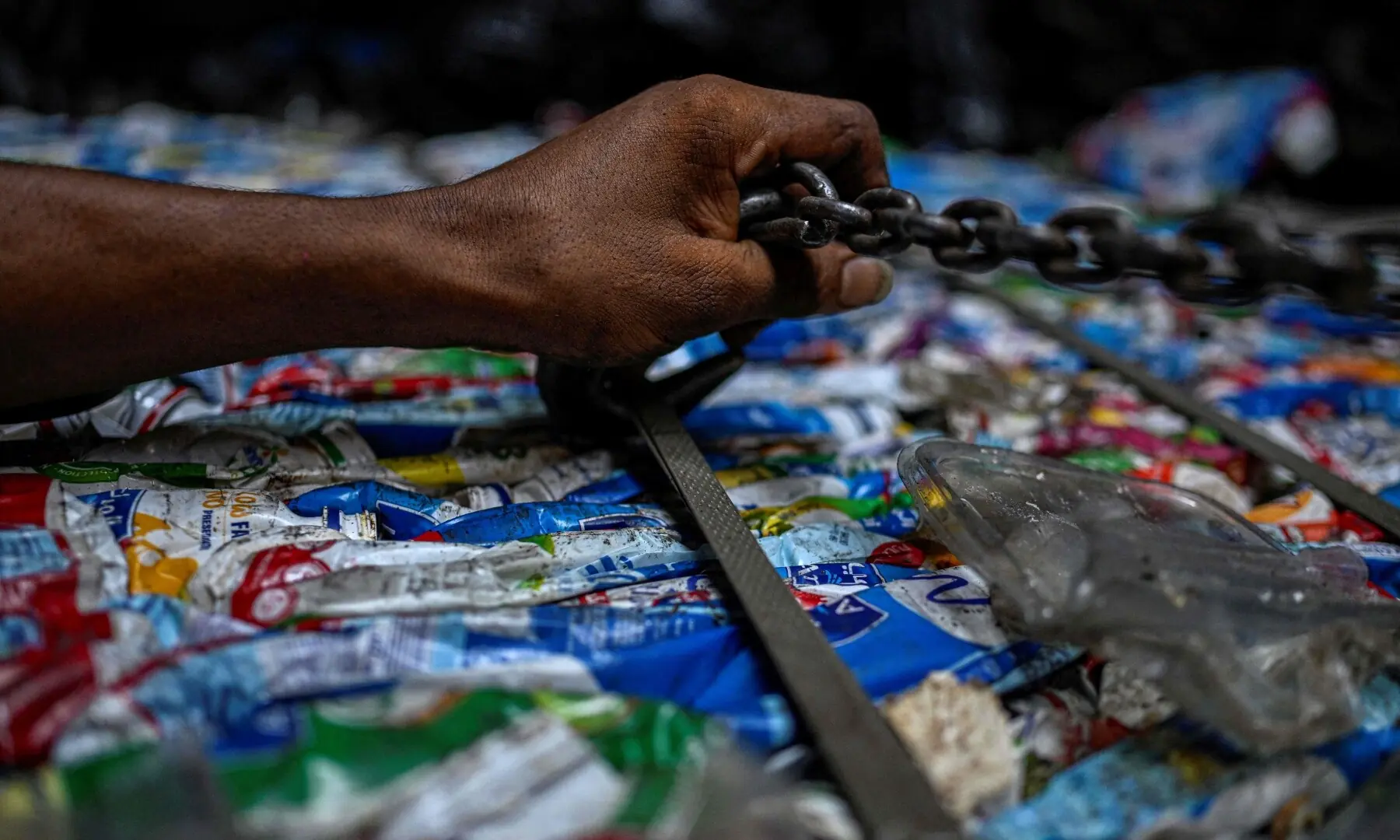 An Egyptian worker scures a bail of plastic before loading on a truck for recycling at the garbage city in the Manshiyet Nasser neighbourhood in Cairo on July 6, 2026. — AFP