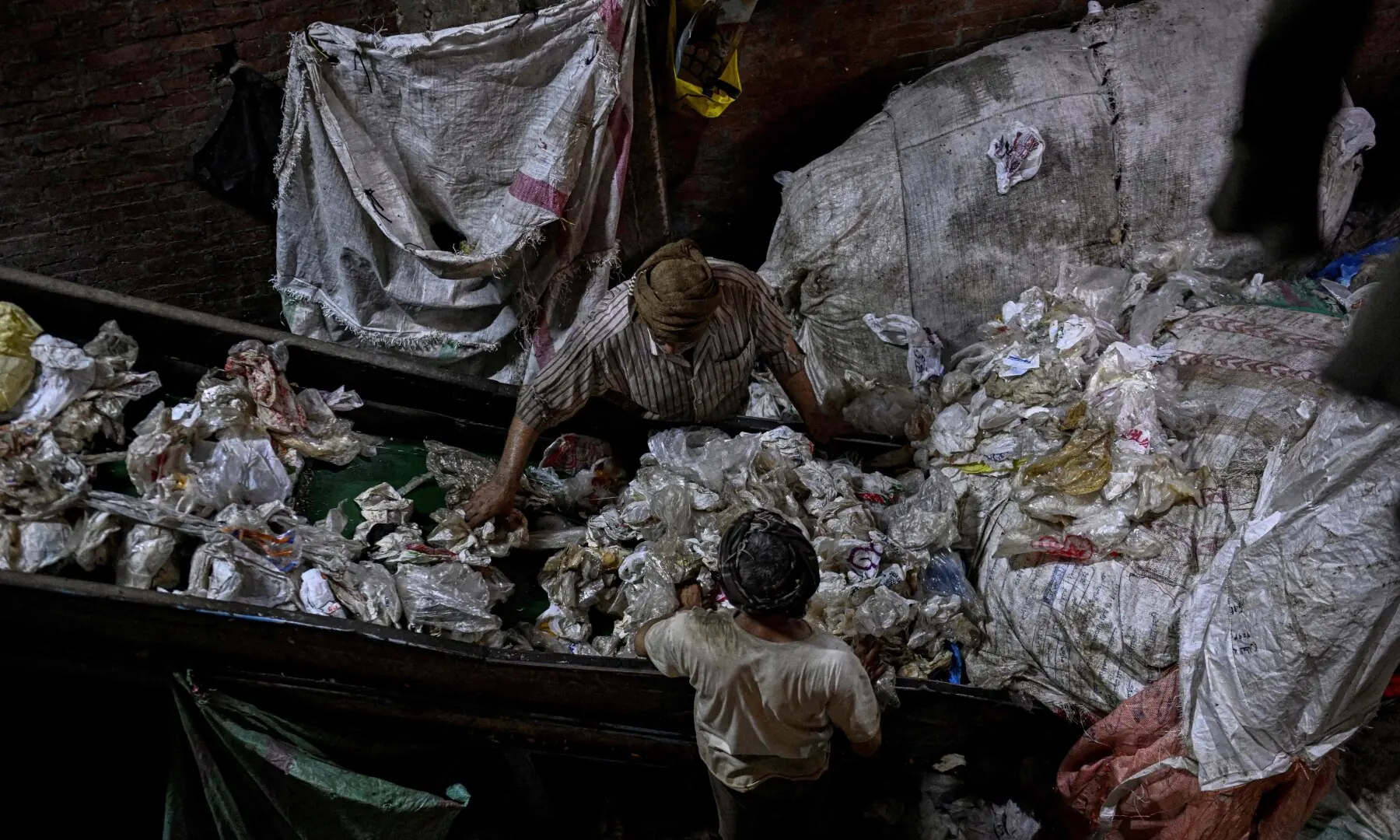 Egyptian workers prepare plastic for processing at a recycling plant at the garbage city in the Manshiyet Nasser neighbourhood in Cairo on July 6, 2026. — AFP