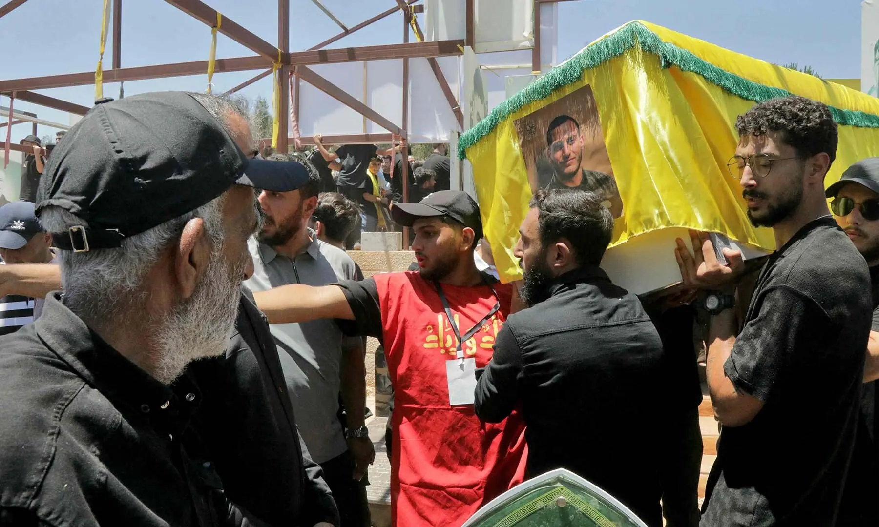 Mourners carry the casket of a Hezbollah fighter who was killed in clashes with the Israeli army during a mass funeral in the southern Lebanese village of Majdel Selm on July 18, 2026. &mdash; AFP