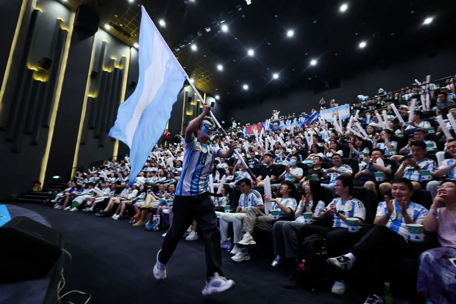 A man displays the national flag of Argentina before the start of a live broadcast of the final match of the FIFA World Cup between Spain and Argentina at a cinema theatre in Beijing, China on July 20, 2026. &mdash; Reuters