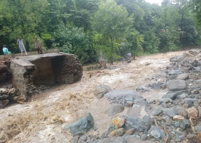Locals watch the remains of a bridge swept away by flash flood in the Moli Nullah stream in Siren Valley on Sunday. — Photo by Nisar Ahmad Khan Locals watch the remains of a bridge swept away by flash flood in the Moli Nullah stream in Siren Valley on Sunday. — Photo by Nisar Ahmad Khan
