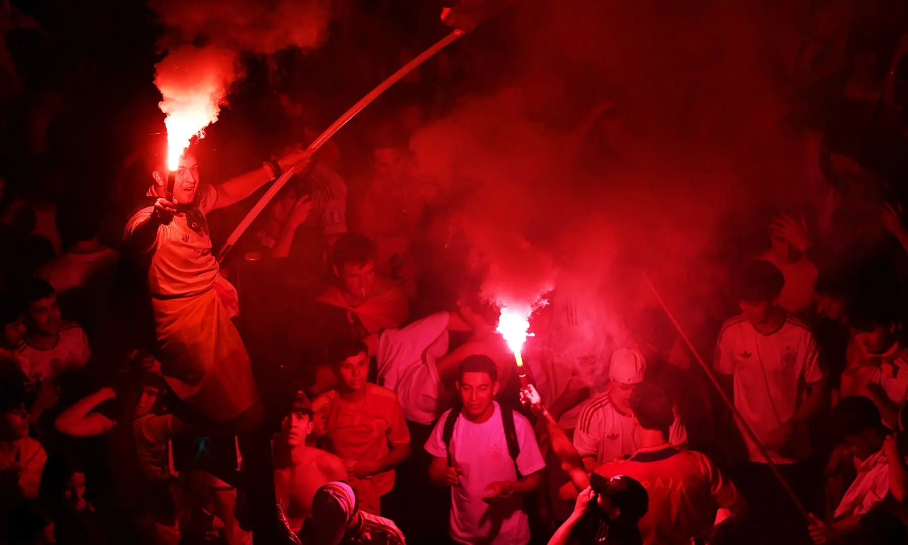 Spain fans light flares as they celebrate at Plaza de Cibeles in Madrid after Spain win the FIFA World Cup final against Argentina. — Reuters