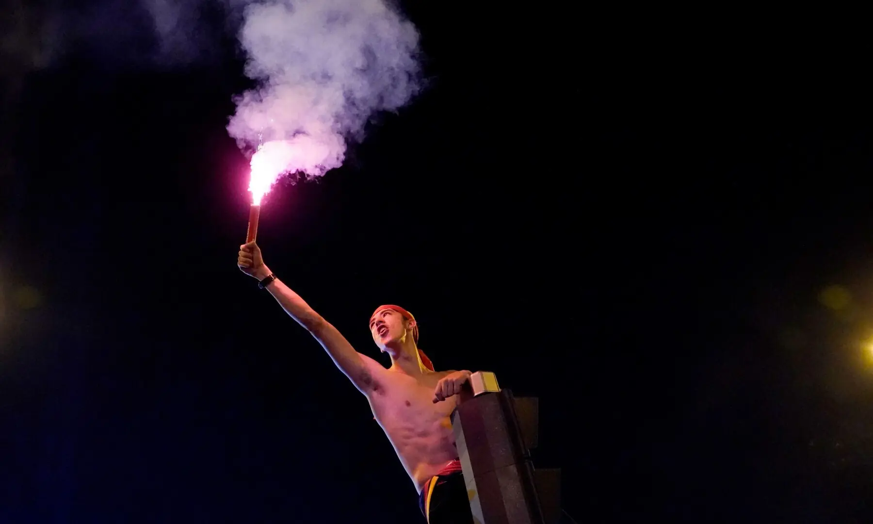 Spain fan lights a flare as they celebrate at Plaza de Cibeles in Madrid after Spain win the FIFA World Cup final against Argentina. — Reuters