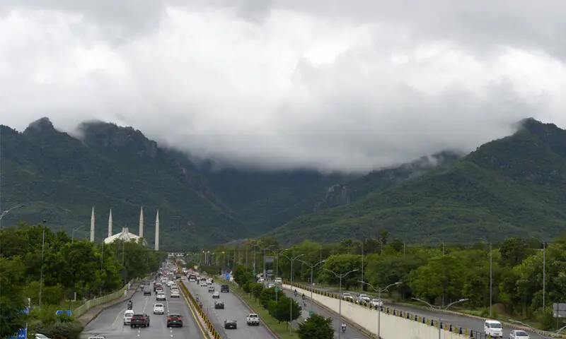 Clouds hang over the Margalla Hills in Islamabad on Tuesday. The capital received intermittent rain throughout the day, with the Met Office predicting more rains in the next few days. &mdash; Photo by Mohammad Asim