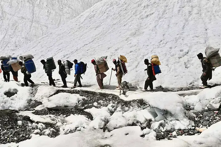 Local porters carry the luggage of foreign climbers heading towards K2 base camp. —Photo by the writer Local porters carry the luggage of foreign climbers heading towards K2 base camp. —Photo by the writer