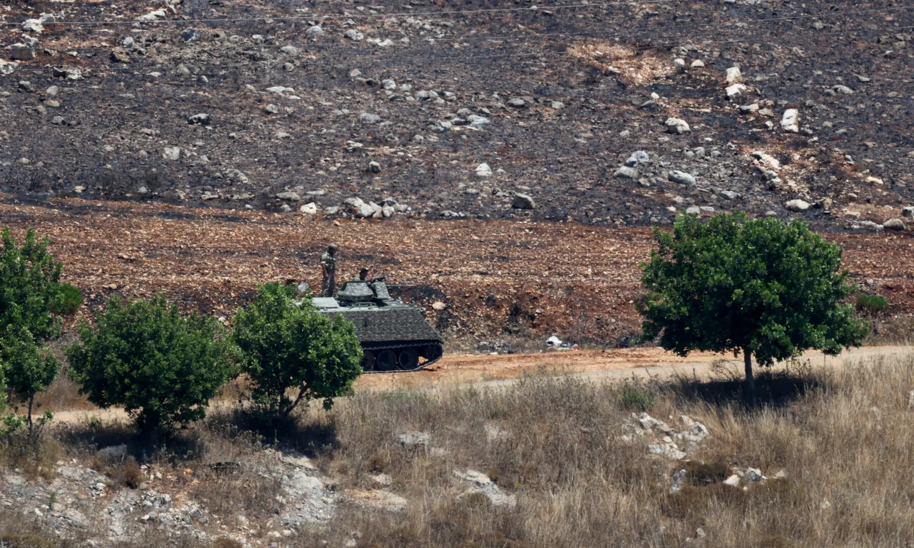 A Lebanese army Armoured Personnel Carrier (APC) stands at the entrance of Zawtar al-Gharbiyeh, as Lebanese army troops deploy in the area following the withdrawal of Israeli forces, under a US-brokered plan, in southern Lebanon, on July 21, 2026. — Reuters