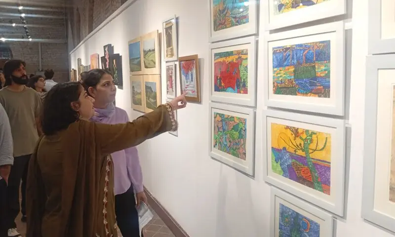 Visitors at a visual art exhibition at NCA. — Dawn Visitors at a visual art exhibition at NCA. — Dawn