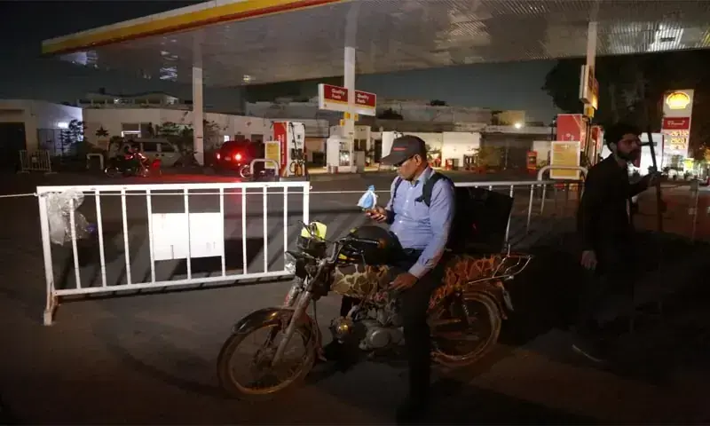A MOTORCYCLIST looking for fuel stands outside a closed petrol pump in Karachi.&mdash;Shakil Adil / White Star/File