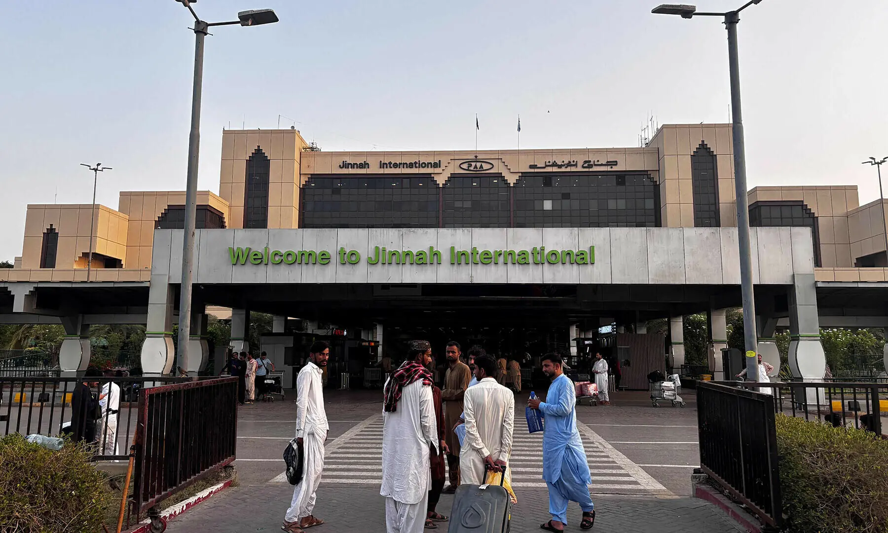 Passengers wait outside at Jinnah International airport after all domestic and international flights were cancelled in Karachi on May 7. — AFP/File Passengers wait outside at Jinnah International airport after all domestic and international flights were cancelled in Karachi on May 7. — AFP/File