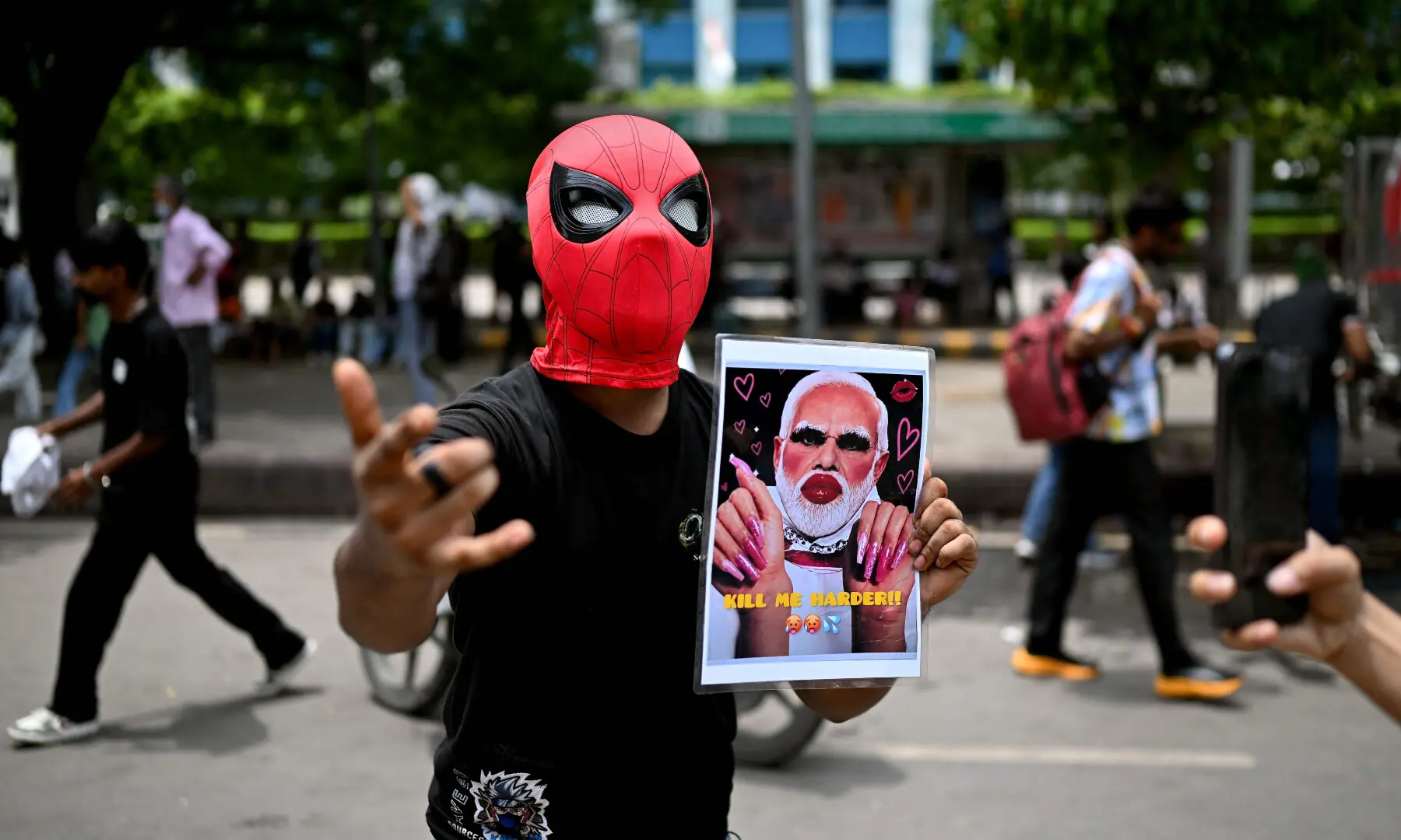  A Cockroach Janta Party (CJP) supporter holds a placard of India’s Prime Minister Narendra Modi at Jantar Mantar in New Delhi on July 25, 2026 during the ongoing protest to demand the resignation of India’s Education Minister Dharmendra Pradhan over alleged NEET exam irregularities. — AFP 