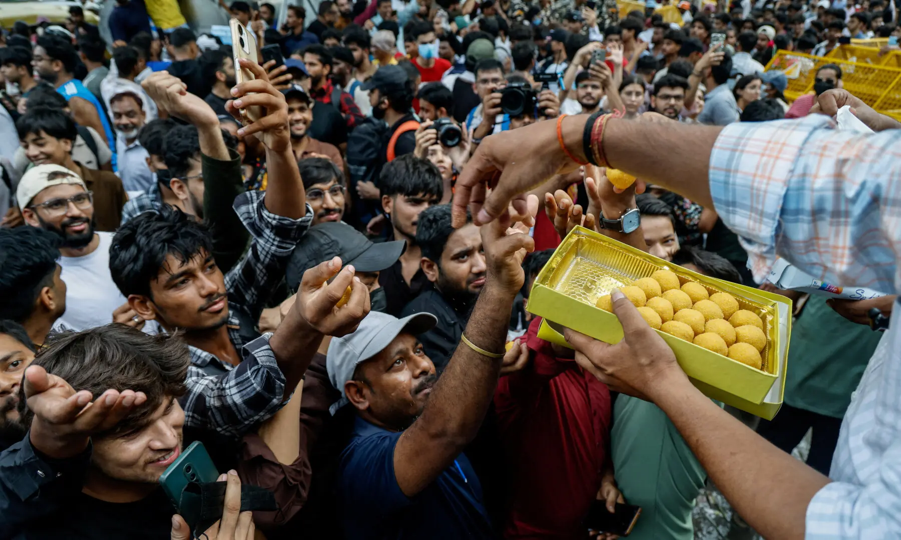  A man hands out sweets to supporters of India’s Cockroach Janta Party (CJP) as they celebrate after India’s Education Minister Dharmendra Pradhan resigned, in New Delhi on July 25, 2026. — Reuters 