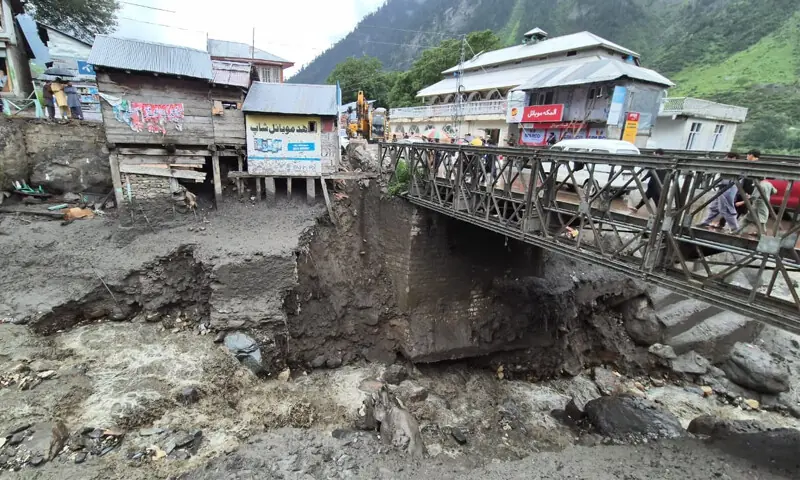 Vehicles cross the flood-damaged bridge in Kaghan town. — Dawn Vehicles cross the flood-damaged bridge in Kaghan town. — Dawn