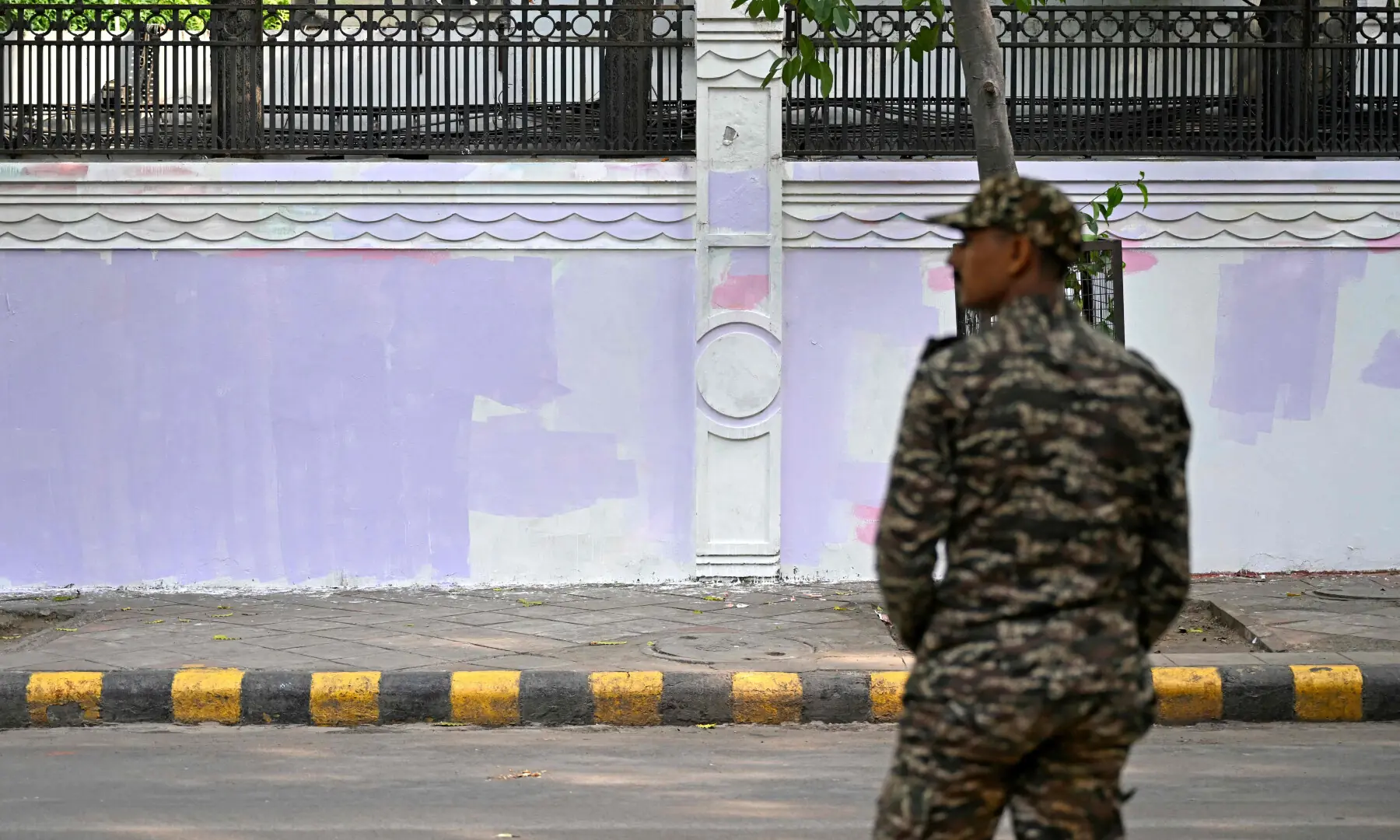 A security personnel stands guard in front of a freshly painted wall after authorities covered up anti-government graffiti drawn by the Cockroach Janta Party (CJP) supporters at Jantar Mantar in New Delhi on July 26, 2026. — AFP A security personnel stands guard in front of a freshly painted wall after authorities covered up anti-government graffiti drawn by the Cockroach Janta Party (CJP) supporters at Jantar Mantar in New Delhi on July 26, 2026. — AFP